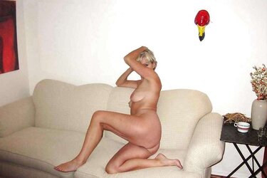 Justine a mature platinum-blonde posing on a couch