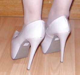 Trampy secretary in girdle, pantyhose and platform high-heeled slippers