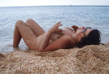 Inexperienced mature possing nude outdoors on the beach