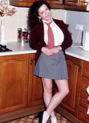 Adorable brown-haired disrobing in her kitchen