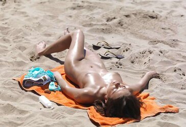 Luxurious youthful woman bare on the beach