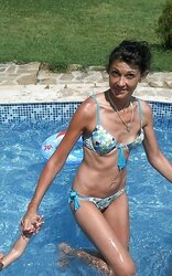 Mommy in swimsuit nearly showcasing her tiny jugs