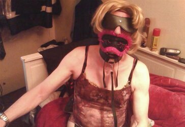 Annie blindfolded and ball-gagged