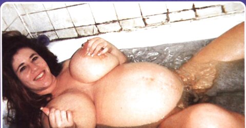 Gigantic-titted pregnant black-haired posing in her tub