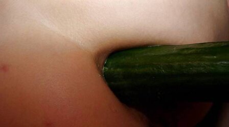 Super-Bitch plays with a cucumber
