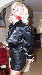 Light-Haired roped up wearing leather miniskirt and high high-heeled slippers